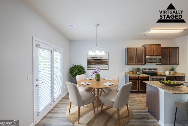 1003 Eldon Ln, Fairburn, GA 30213 - dining area with light wood-style floors, visible vents, baseboards, and a notable chandelier