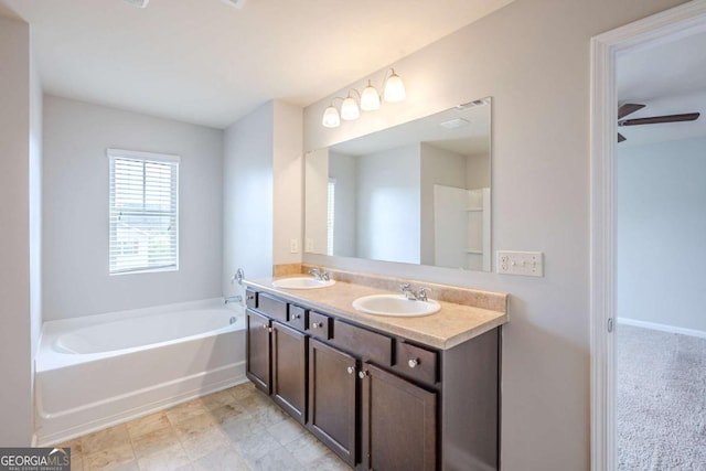 full bathroom featuring a sink, ceiling fan, a garden tub, and double vanity