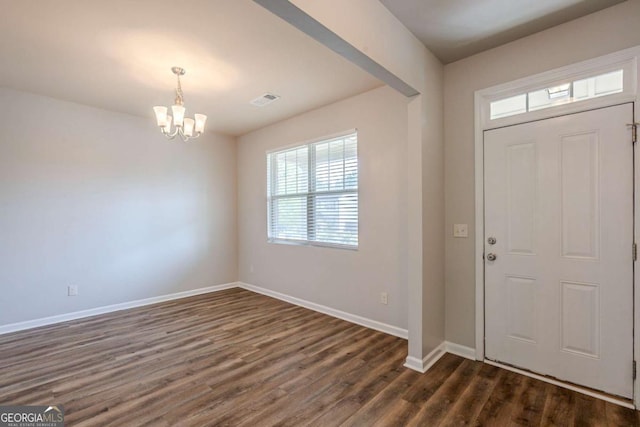 foyer entrance featuring baseboards, visible vents, dark wood-style flooring, and a notable chandelier