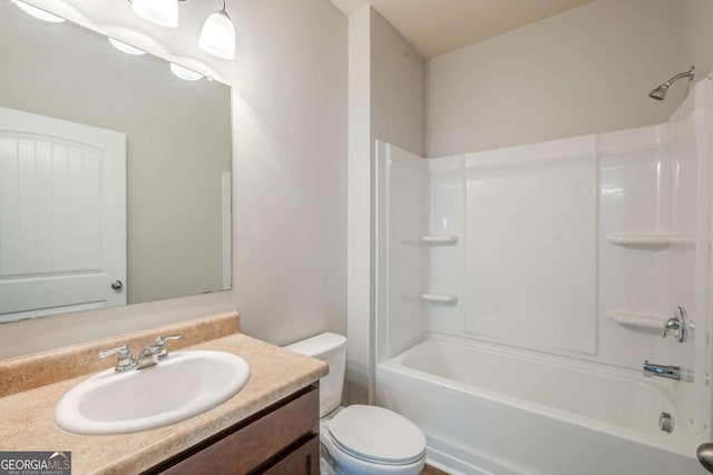 bathroom with vanity, shower / bathing tub combination, and toilet
