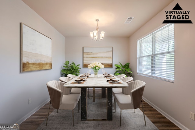 1003 Eldon Ln, Fairburn, GA 30213 - dining room featuring a chandelier, wood finished floors, baseboards, and visible vents