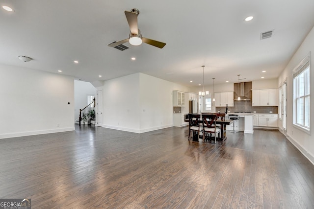 living area featuring a ceiling fan, visible vents, dark wood finished floors, and recessed lighting