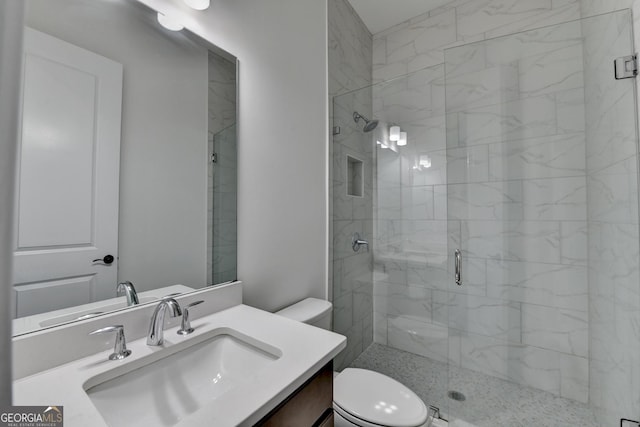 full bath with vanity, a stall shower, and toilet