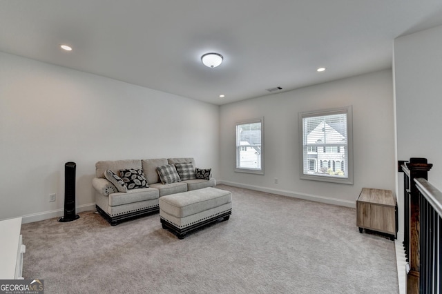 living area with recessed lighting, baseboards, visible vents, and light carpet
