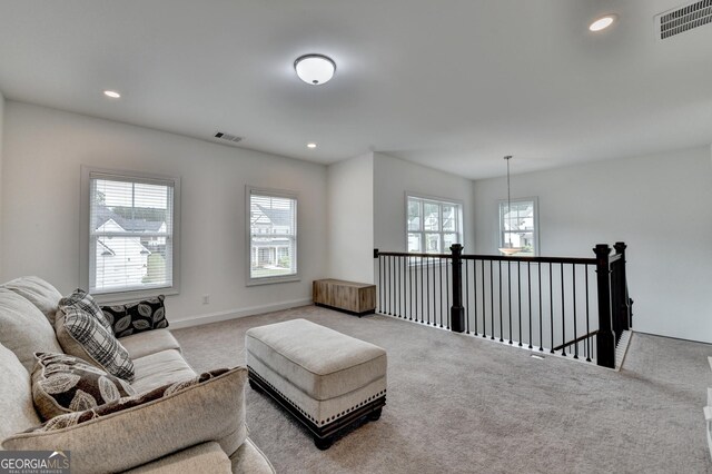 carpeted living room with recessed lighting and visible vents