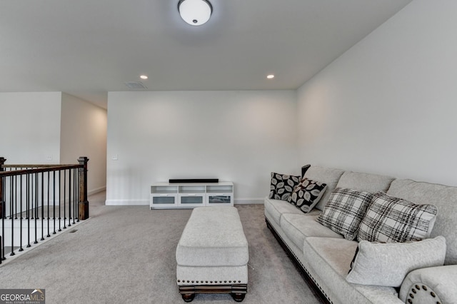carpeted living area featuring recessed lighting, baseboards, and visible vents