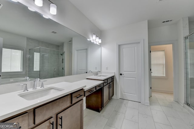 bathroom with a sink, visible vents, a shower stall, and marble finish floor