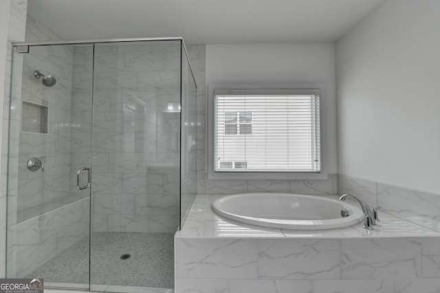 full bathroom featuring a bath and a stall shower