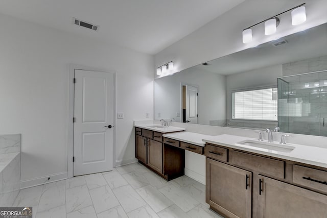 bathroom with a sink, a stall shower, and marble finish floor