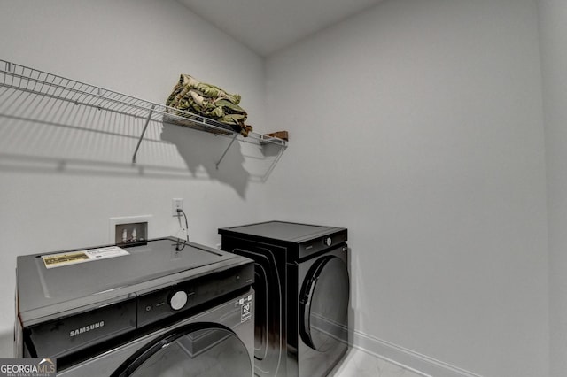 laundry room with separate washer and dryer, baseboards, laundry area, and marble finish floor