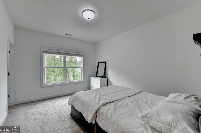 carpeted bedroom with baseboards and visible vents