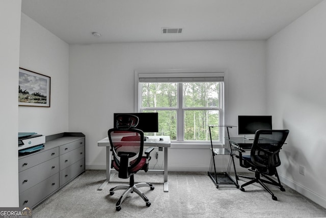 carpeted office space featuring visible vents and baseboards