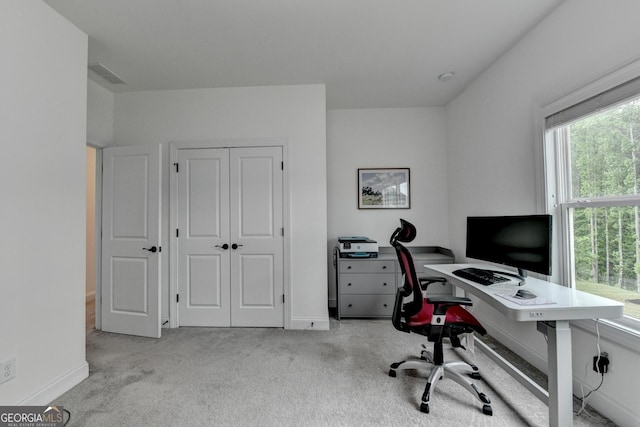carpeted office featuring visible vents and baseboards