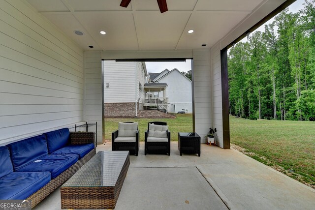 view of patio with an outdoor living space and ceiling fan