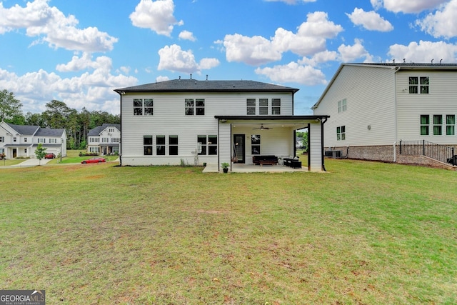 back of property featuring a lawn, a ceiling fan, a patio area, and central AC unit