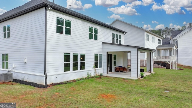 back of house featuring a patio area, central air condition unit, and a yard
