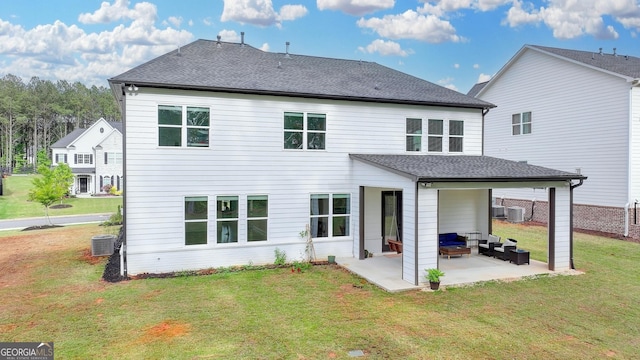 rear view of property featuring a lawn, central AC, a shingled roof, and a patio area