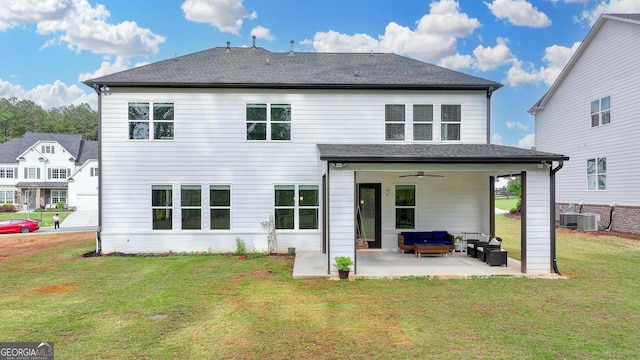 rear view of property featuring roof with shingles, ceiling fan, outdoor lounge area, a patio, and a yard