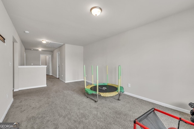 rec room with baseboards, attic access, and carpet