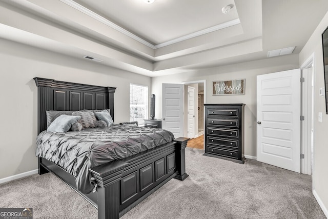 bedroom with visible vents, ornamental molding, a raised ceiling, and carpet floors