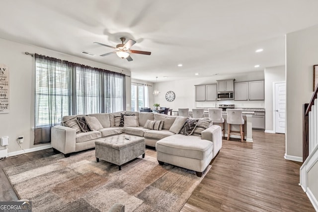 living room with ceiling fan, recessed lighting, wood finished floors, and visible vents