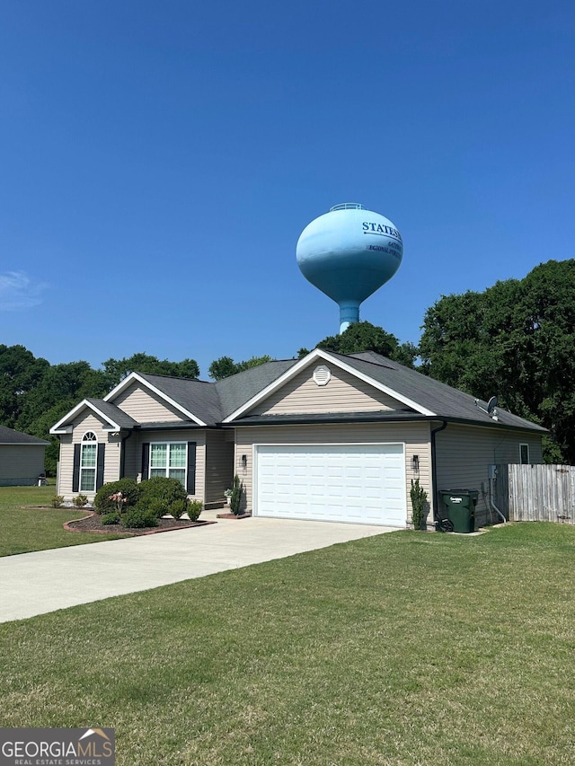 ranch-style home featuring an attached garage and driveway