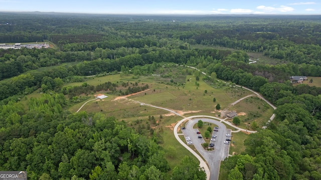 drone / aerial view with a wooded view