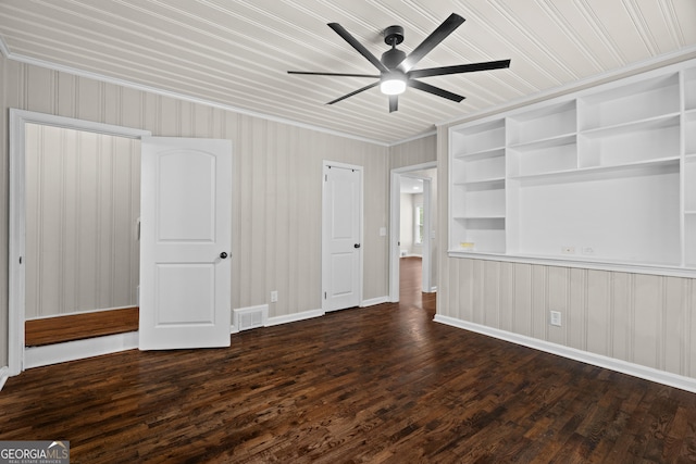 unfurnished bedroom featuring baseboards, ornamental molding, dark wood-style floors, and visible vents