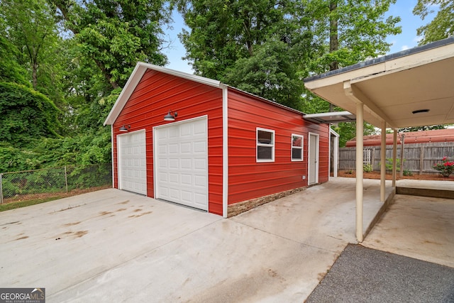 detached garage featuring fence
