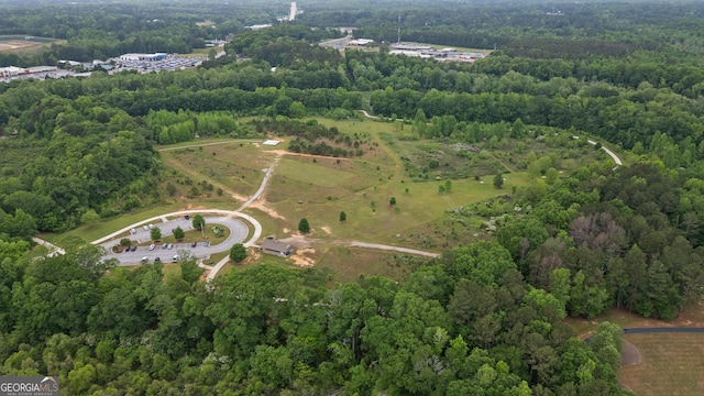 drone / aerial view featuring a forest view