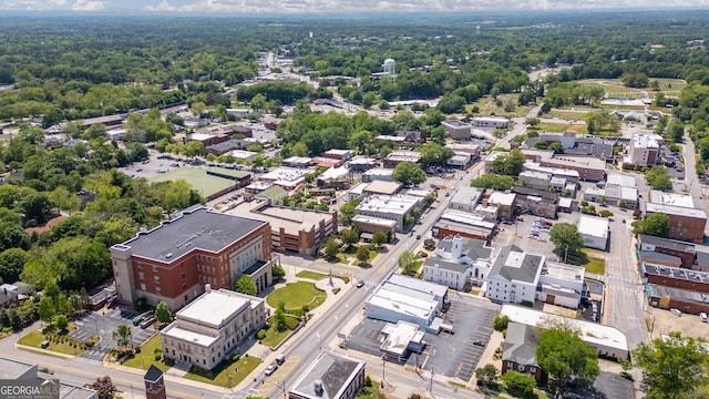 drone / aerial view with a wooded view