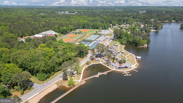 drone / aerial view featuring a water view and a wooded view