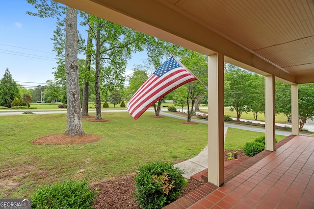 view of yard featuring covered porch