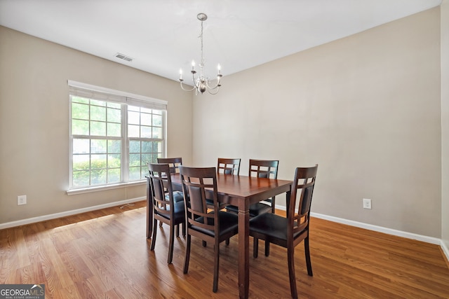 1355 Hesse Ln, Austell, GA 30106 - dining space featuring a chandelier, baseboards, visible vents, and wood finished floors