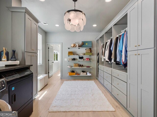650 Jones Rd, Roswell, GA 30075 - spacious closet featuring visible vents, light wood-type flooring, and washing machine and clothes dryer