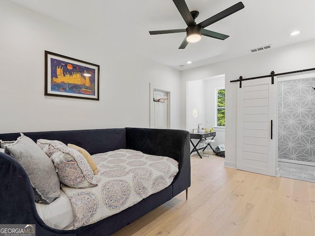 650 Jones Rd, Roswell, GA 30075 - bedroom featuring recessed lighting, visible vents, a barn door, and wood finished floors