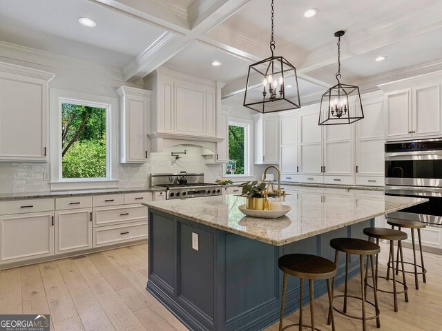 650 Jones Rd, Roswell, GA 30075 - kitchen with white cabinetry, range, and stainless steel double oven