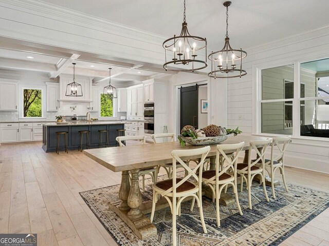 650 Jones Rd, Roswell, GA 30075 - dining room featuring an inviting chandelier, a wealth of natural light, and light wood-style flooring