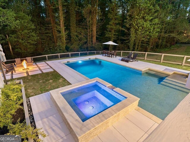 650 Jones Rd, Roswell, GA 30075 - view of swimming pool featuring a fenced backyard, a view of trees, a patio, and a fire pit