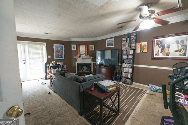 living area featuring visible vents, carpet flooring, a ceiling fan, and a fireplace