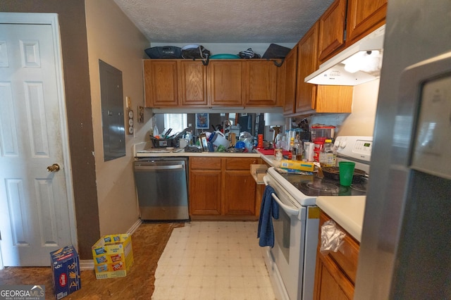 kitchen featuring light countertops, brown cabinetry, stainless steel appliances, light floors, and under cabinet range hood