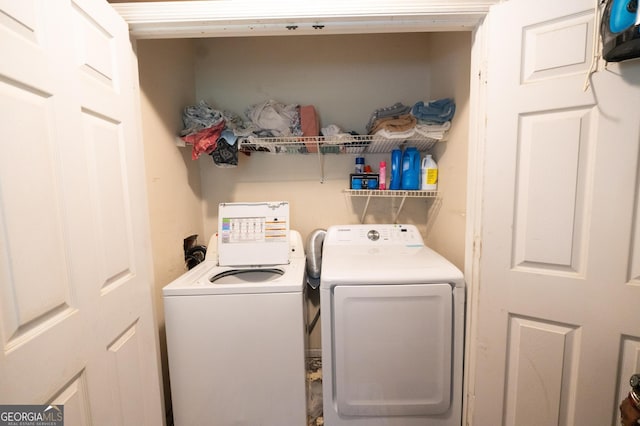 clothes washing area featuring washer and dryer and laundry area