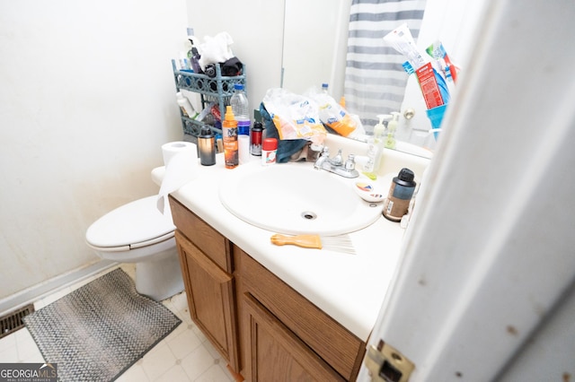 bathroom featuring vanity, visible vents, and toilet