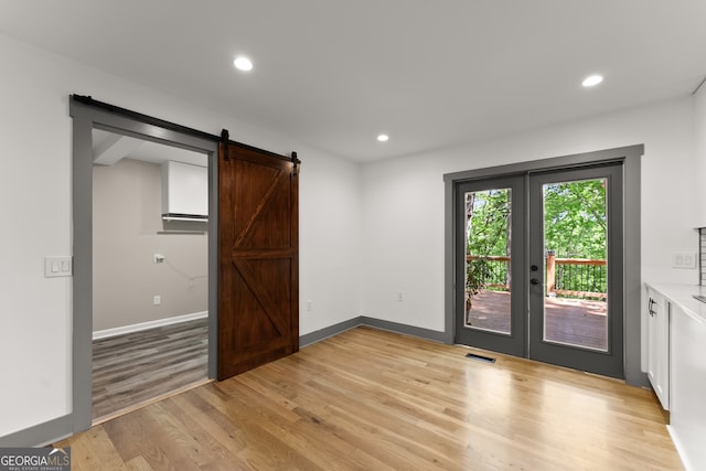 364 Cherokee Trce, Dahlonega, GA 30533 - interior space with visible vents, a barn door, light wood finished floors, and french doors