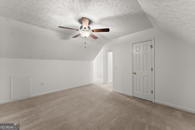 364 Cherokee Trce, Dahlonega, GA 30533 - bonus room with ceiling fan, a textured ceiling, baseboards, lofted ceiling, and light carpet