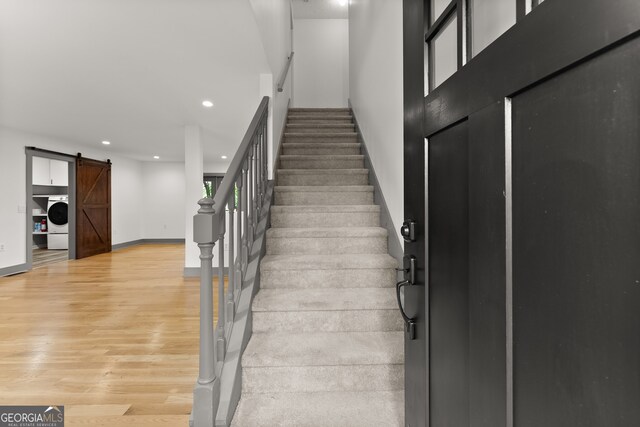 364 Cherokee Trce, Dahlonega, GA 30533 - stairway with a barn door, recessed lighting, baseboards, washer / dryer, and wood finished floors