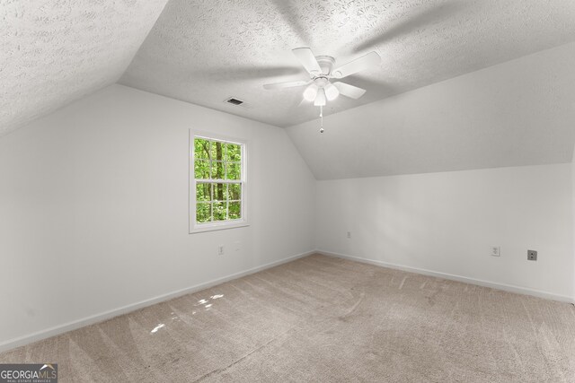 364 Cherokee Trce, Dahlonega, GA 30533 - additional living space featuring visible vents, lofted ceiling, baseboards, light colored carpet, and a ceiling fan