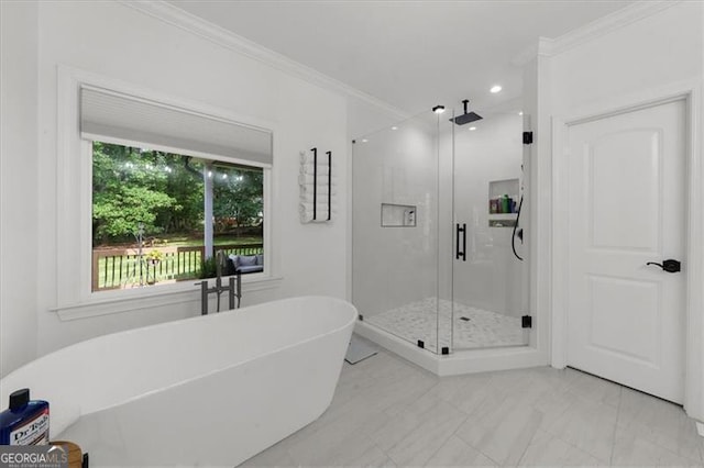 bathroom with ornamental molding, a soaking tub, a shower stall, and marble finish floor