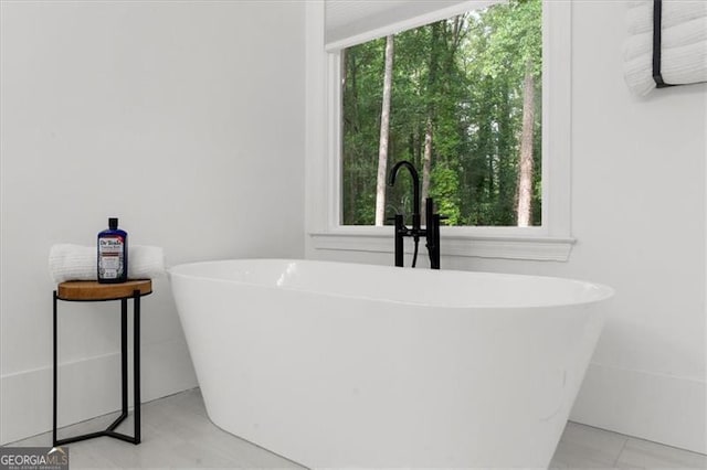 bathroom with a soaking tub