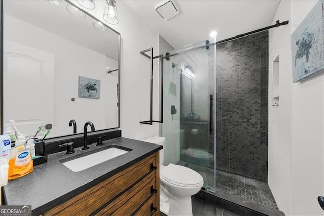full bathroom with vanity, a shower stall, toilet, and visible vents